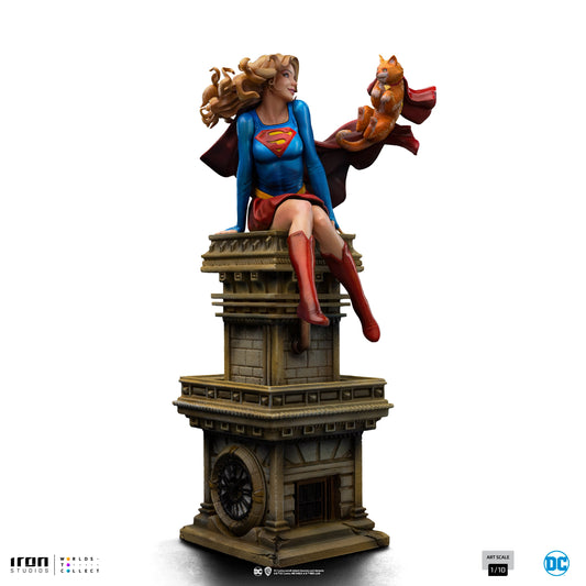 Supergirl statue on a pedestal with a white background